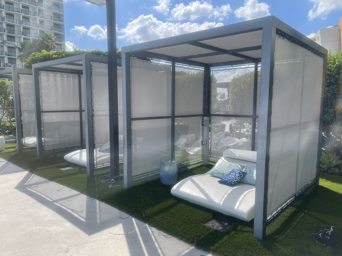 Poolside cabanas with translucent curtains