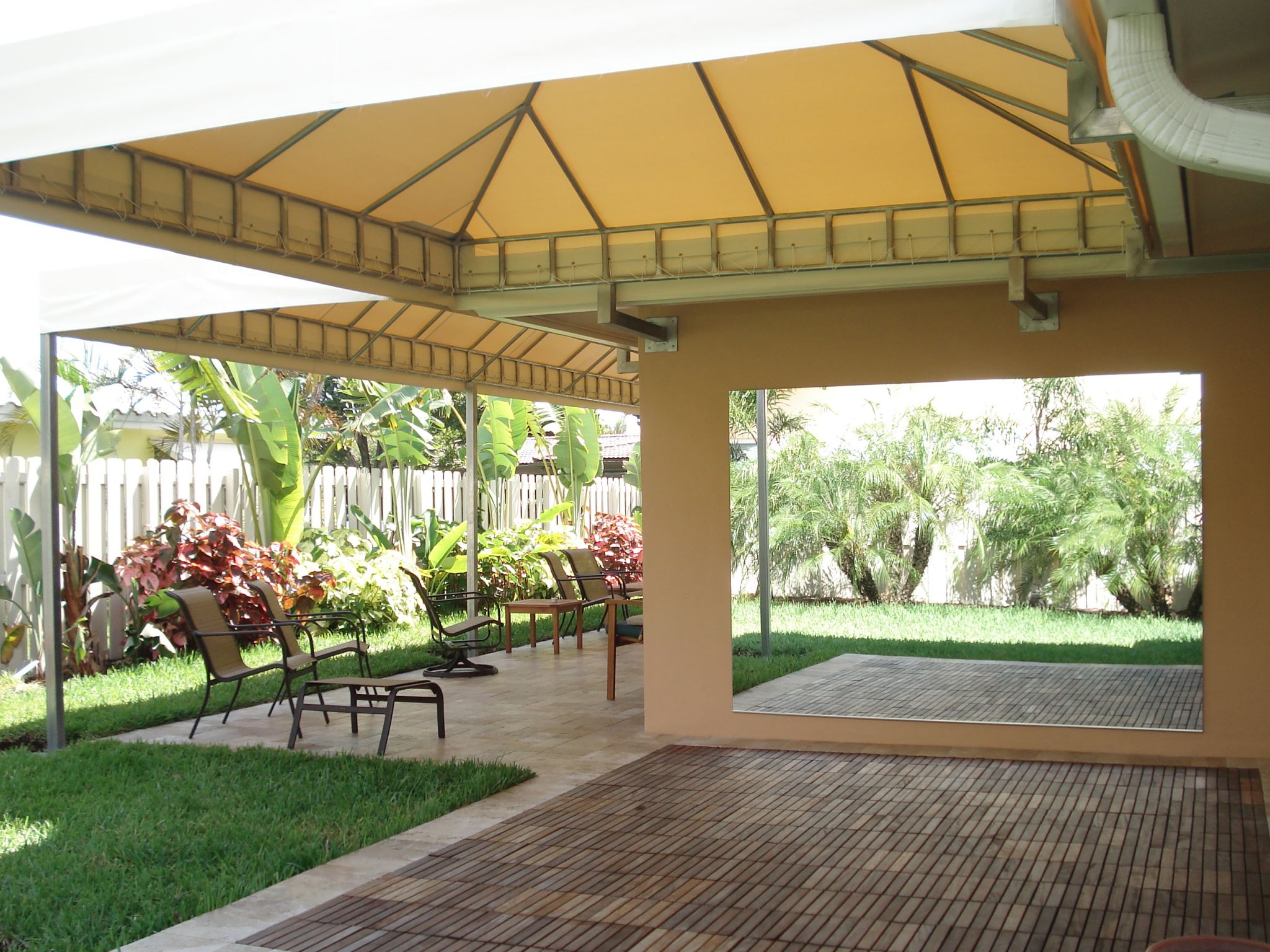 Gold retractable patio awning — South Florida residential