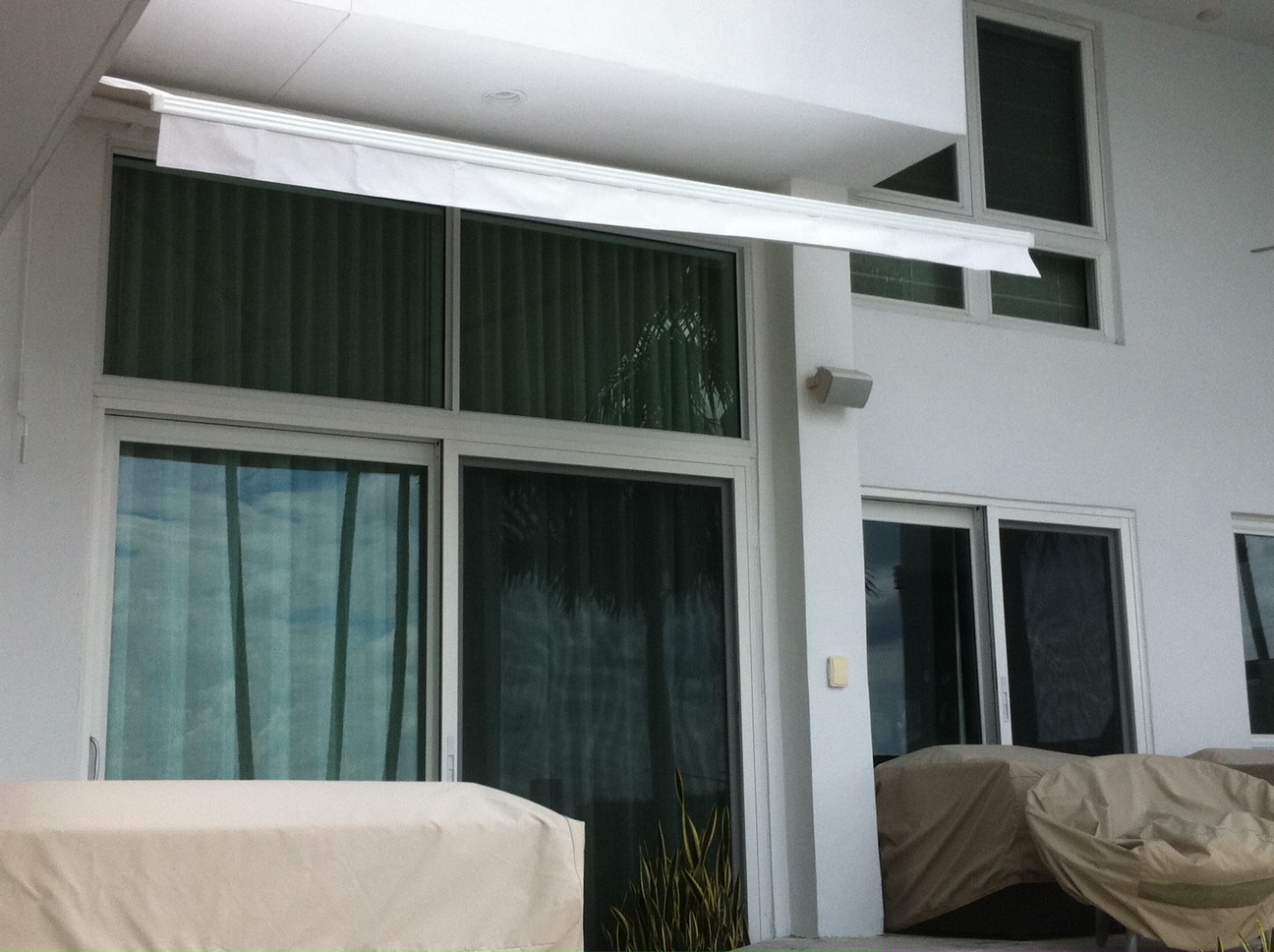 White retractable awning on modern South Florida home